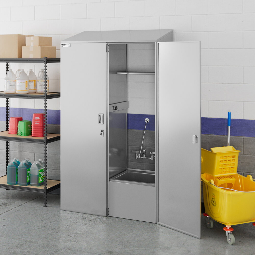 A stainless steel cabinet with open doors revealing a built-in mop sink, situated in a utility room next to cleaning supplies and a yellow mop bucket.