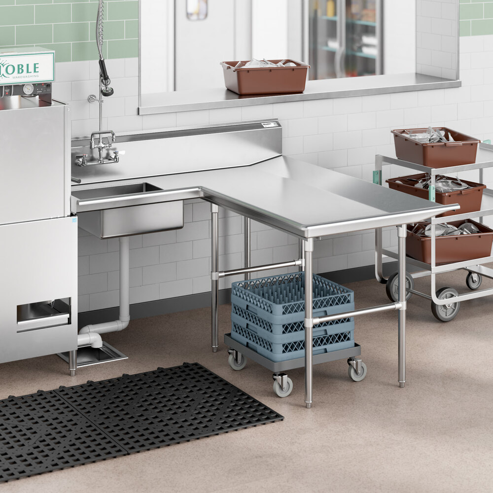 A stainless steel L-shaped dishtable with an integrated sink, positioned in a commercial kitchen setting.