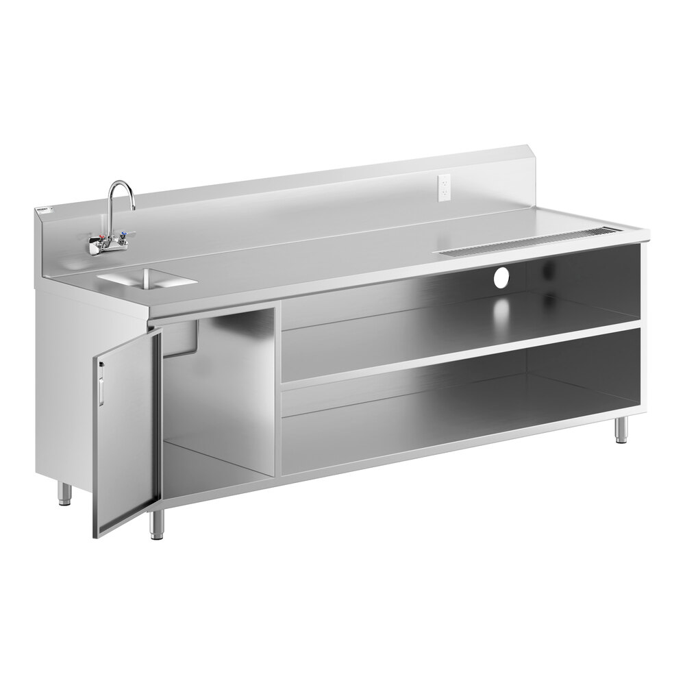 A stainless steel beverage table with a left-side sink, gooseneck faucet, open shelving, and a cabinet door on the left.