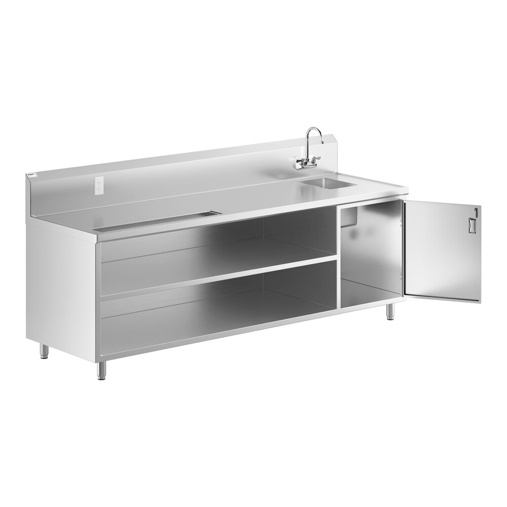 A stainless steel beverage table with a right-side sink, gooseneck faucet, open shelving, and a cabinet with an open door.