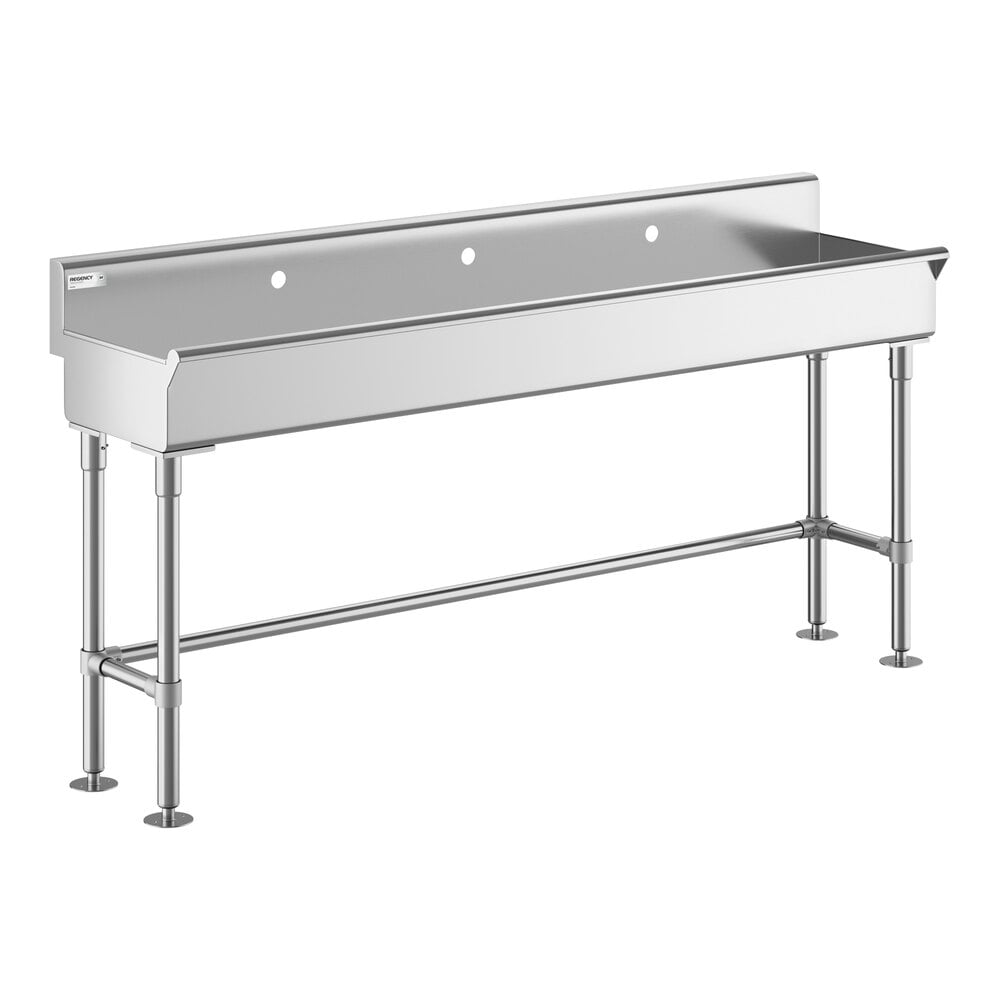 A large, stainless steel hand sink with three faucet holes and four sturdy legs.