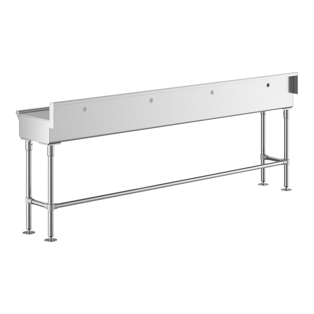 A long, rectangular stainless steel sink with four legs and a backsplash, designed to accommodate multiple faucets.