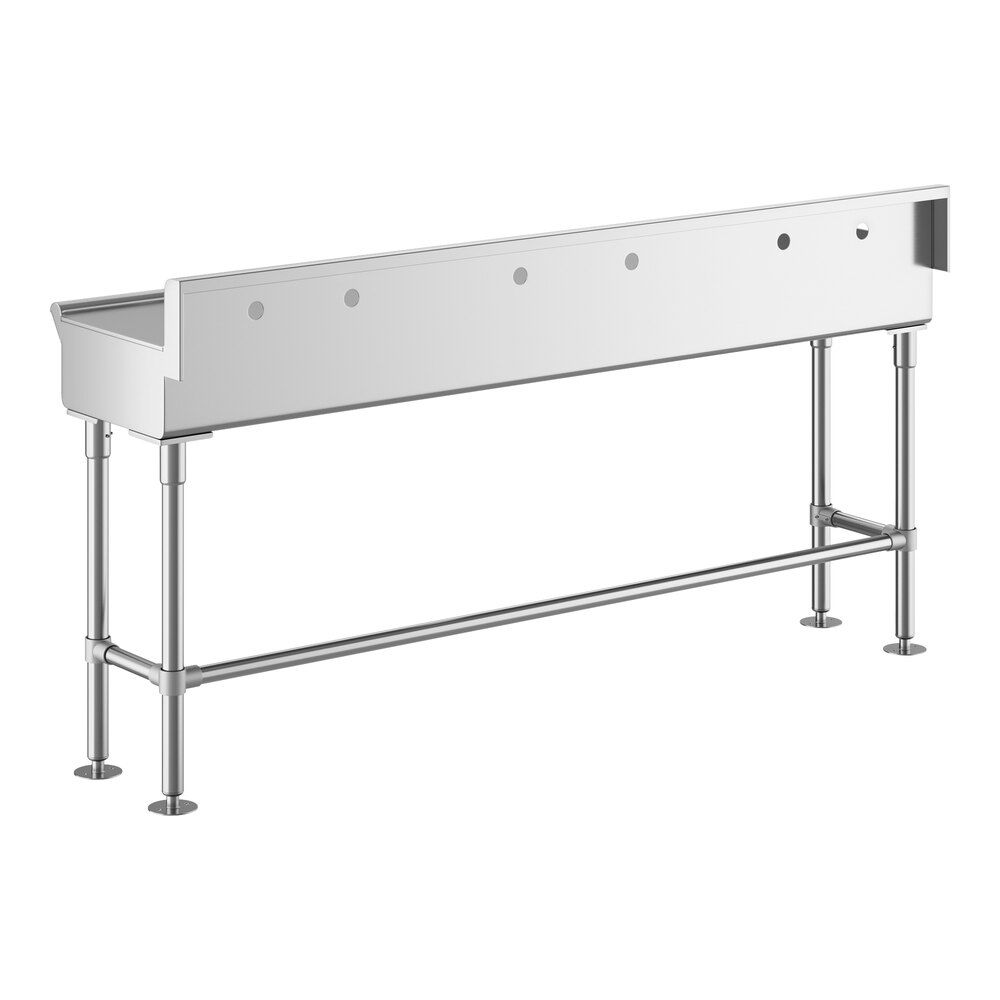 A long, stainless steel hand sink with three faucet holes and sturdy metal legs.