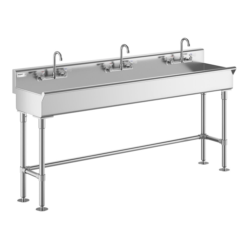 A large stainless steel hand sink with three faucets and sturdy metal legs.