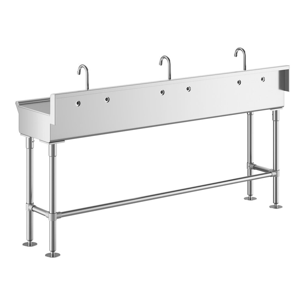 A long, stainless steel hand sink with three gooseneck faucets and four sturdy legs.