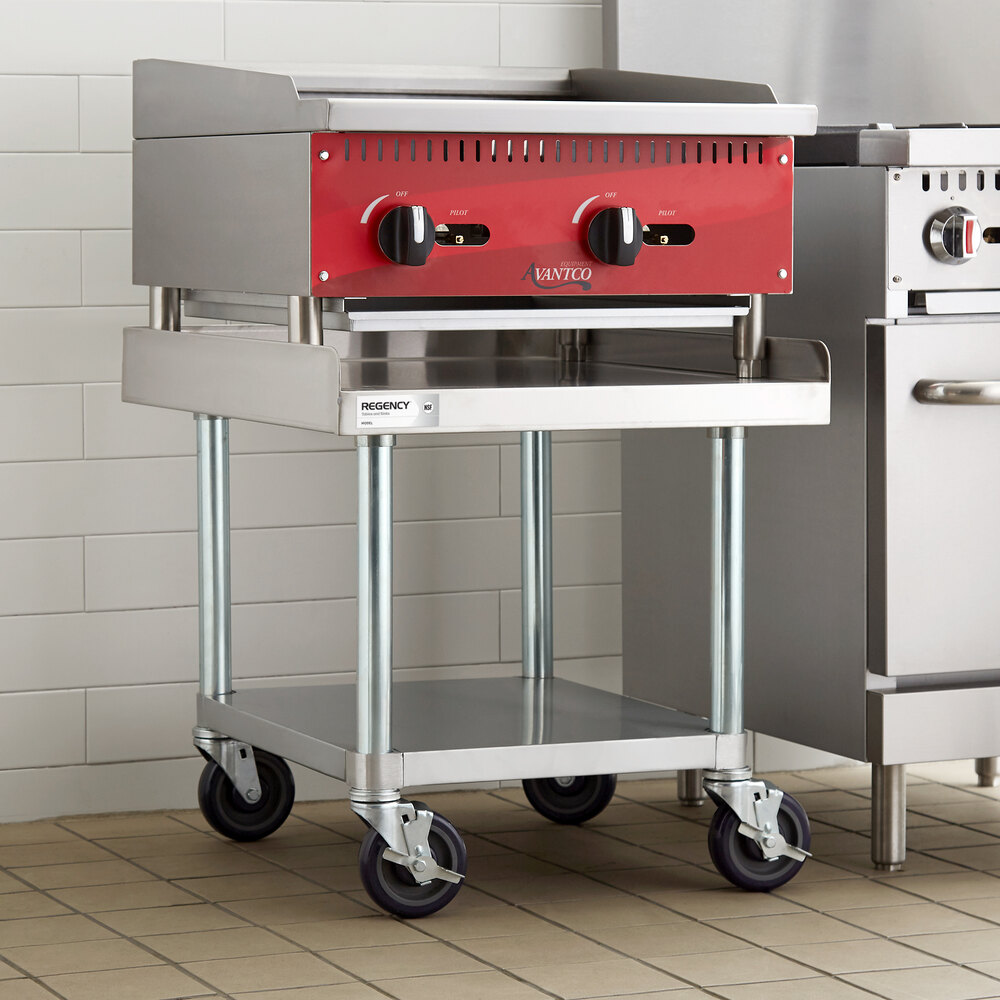 A stainless steel equipment stand with a lower galvanized shelf and four caster wheels, supporting a countertop appliance.
