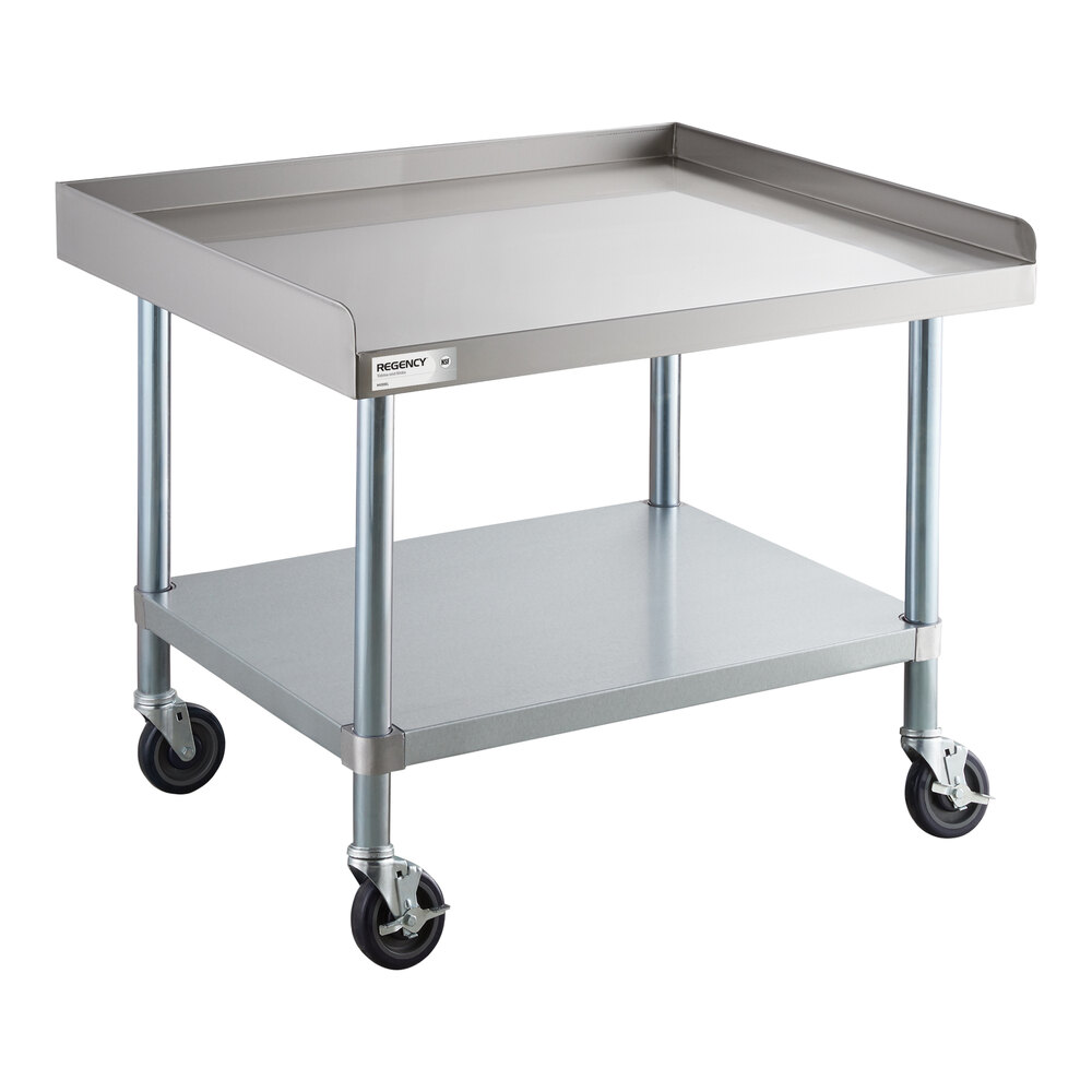 A stainless steel equipment stand with a raised edge, an undershelf, and four caster wheels.