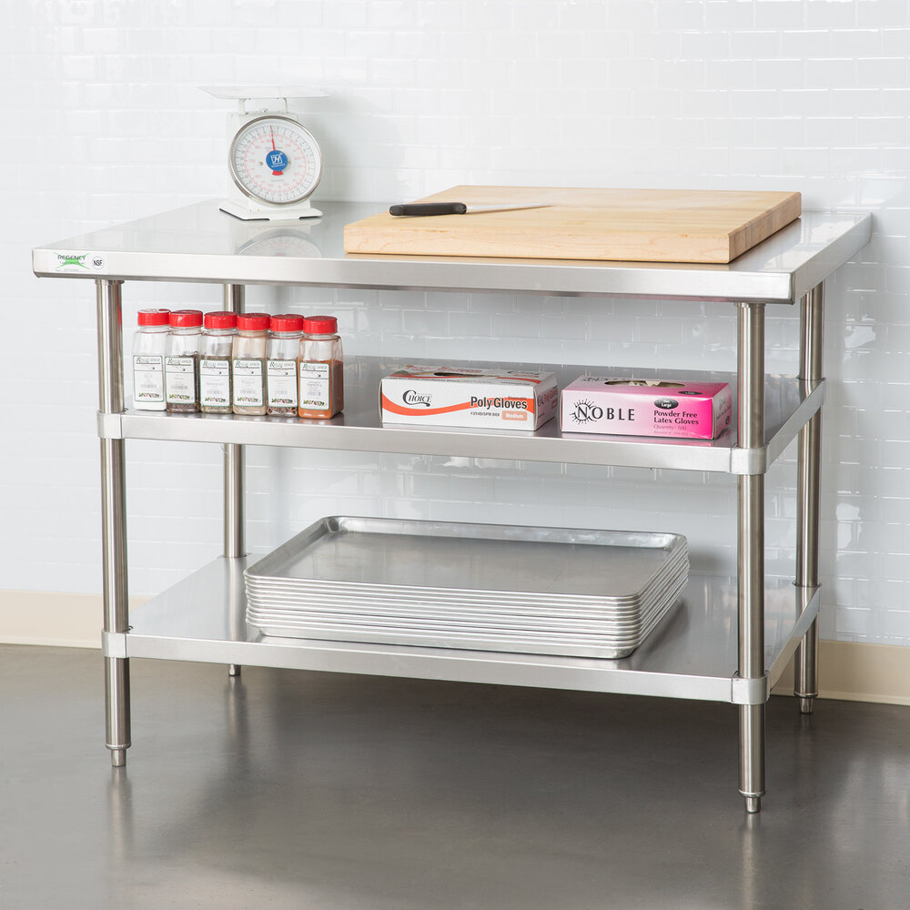 An adjustable stainless steel undershelf designed for 36 x 48 inch work tables, shown installed with kitchen supplies.