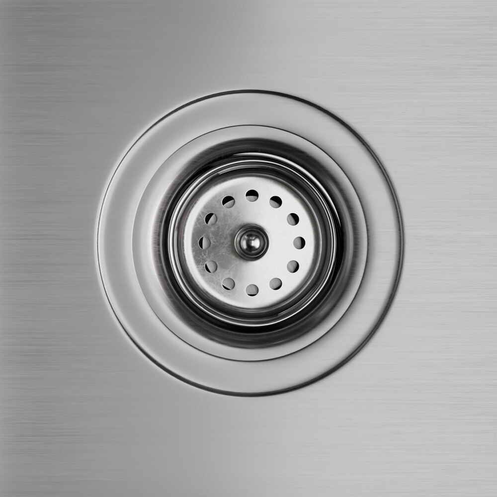 A close-up of a stainless steel sink drain on a Regency hand sink.