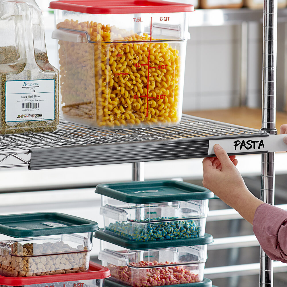 A gray label holder attached to a wire shelving unit, being labeled with the word 'PASTA'.
