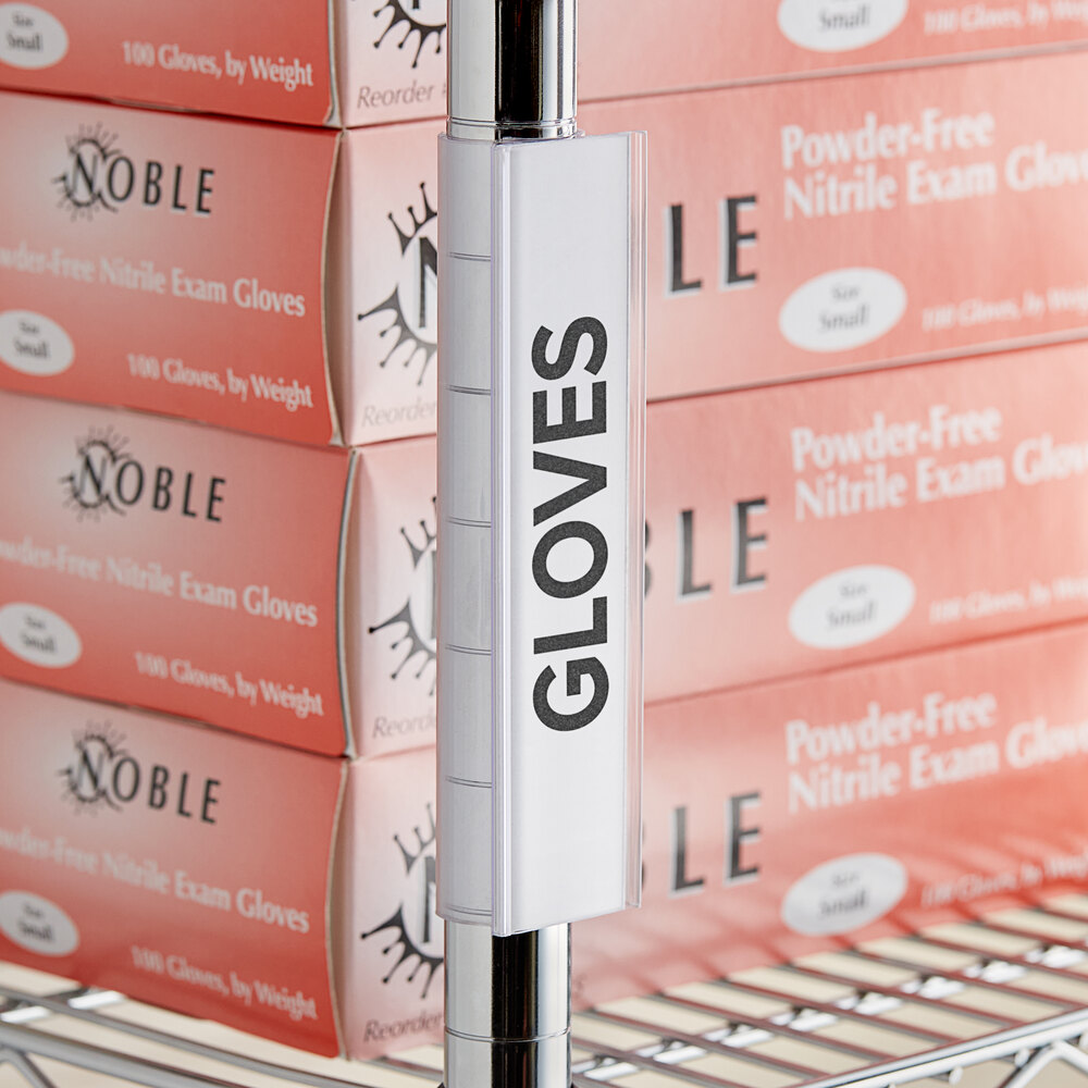 A clear vertical clip-on label holder attached to a metal shelf post, with boxes of gloves in the background.