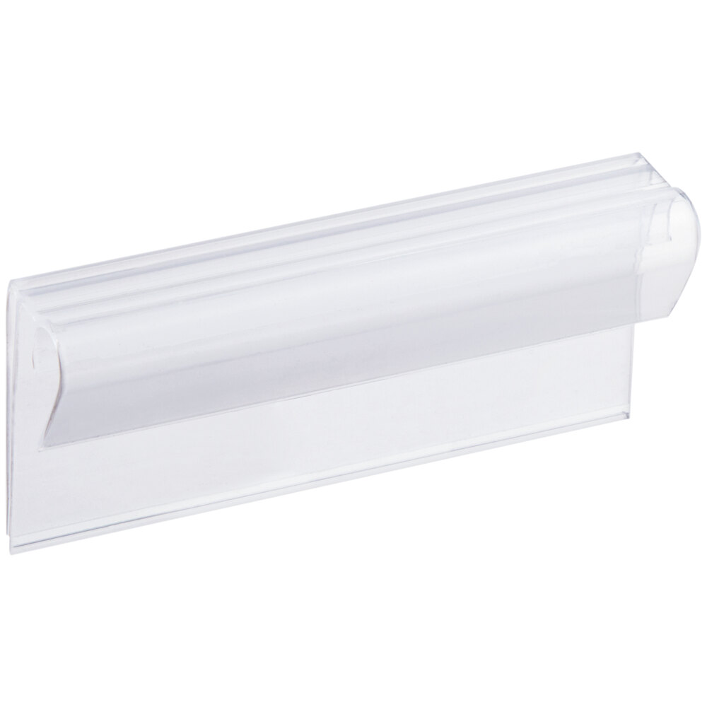 A clear plastic clip-on label holder for shelving, measuring 3 inches by 1 1/4 inches.