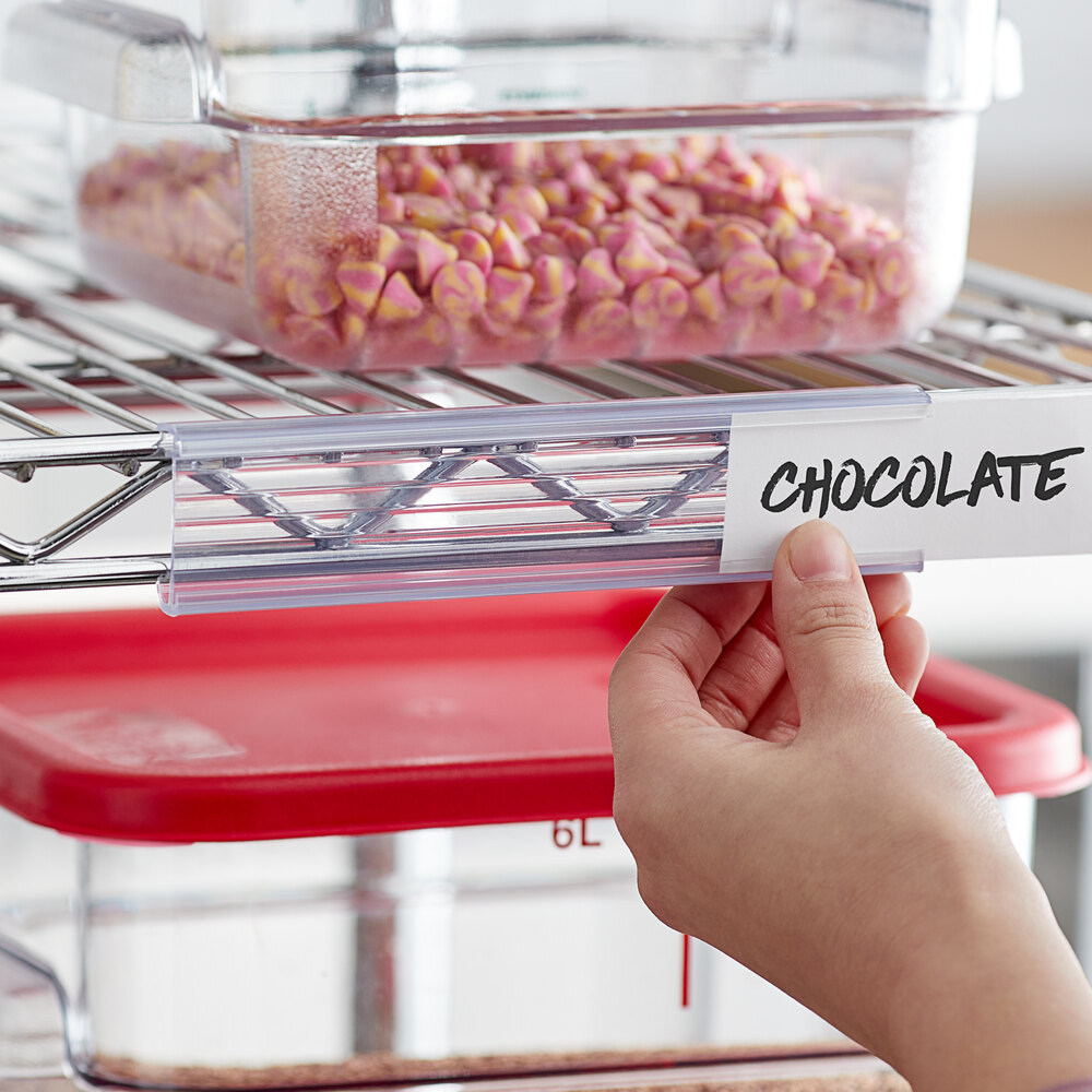 A clear plastic label holder attached to a wire shelf, displaying a label that reads 'CHOCOLATE.'