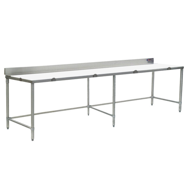 A long stainless steel work table with a white poly top.