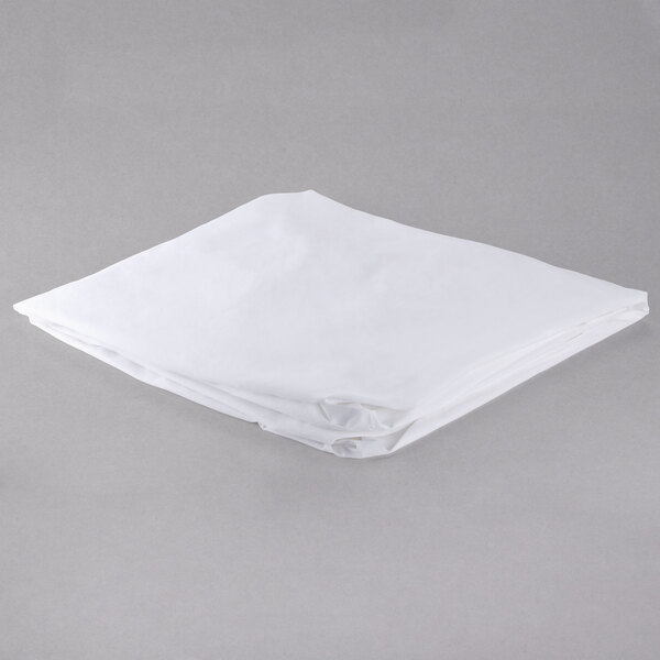 A white folded sheet on a gray surface.