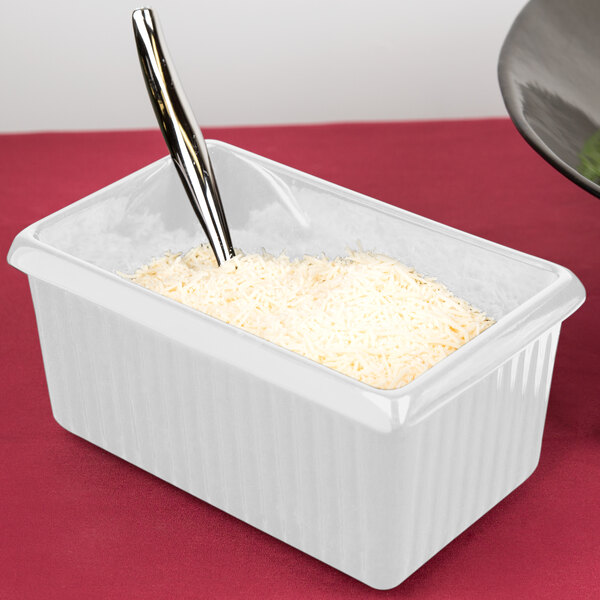 A white Tablecraft rectangular container with white food inside.