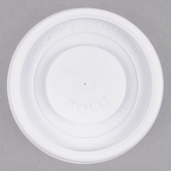 A white plastic Solo lid with a vent for a hot cup.