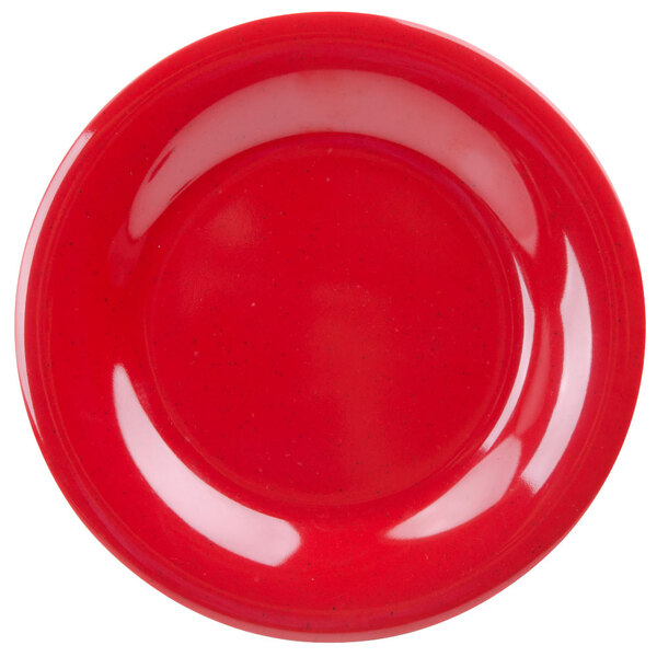 A close up of a red plate with a wide rim.