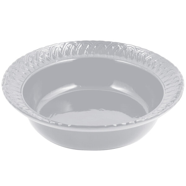 A white Bon Chef cast aluminum bowl with a decorative design on the edge.