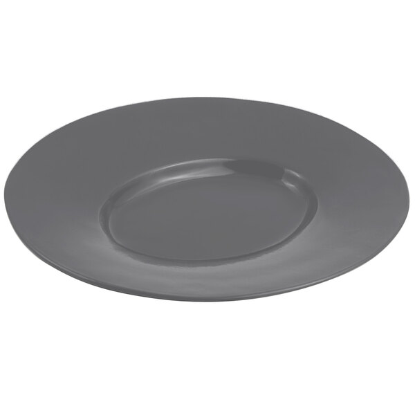 A close-up of a Bon Chef smoke gray cast aluminum wide rim platter with a round rim.