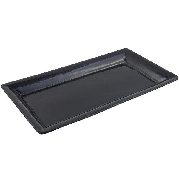 A black rectangular Bon Chef tray with a sandstone finish on a counter.