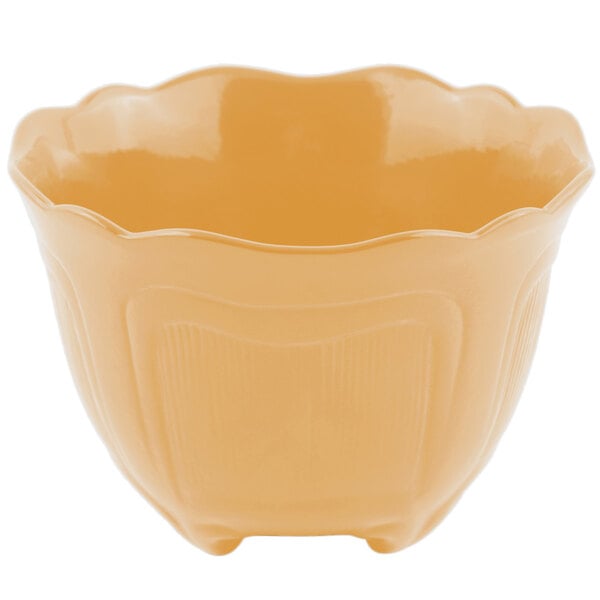 A Bon Chef ginger sandstone garnish bowl with a handle.