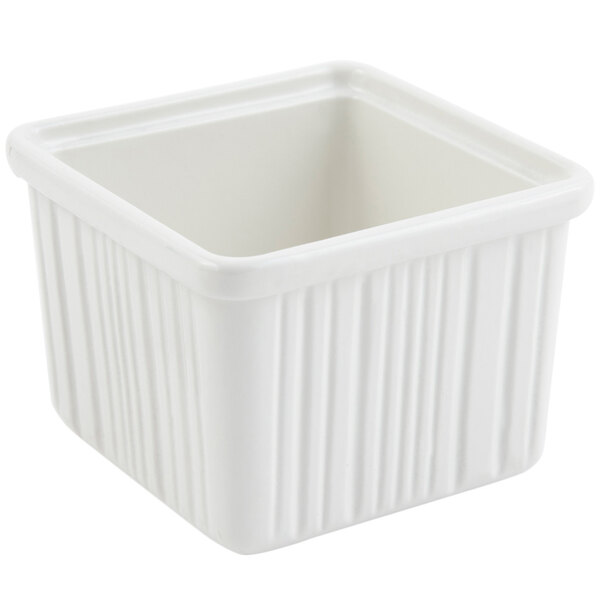 A white square Bon Chef space saver garnish bowl with a square lid.