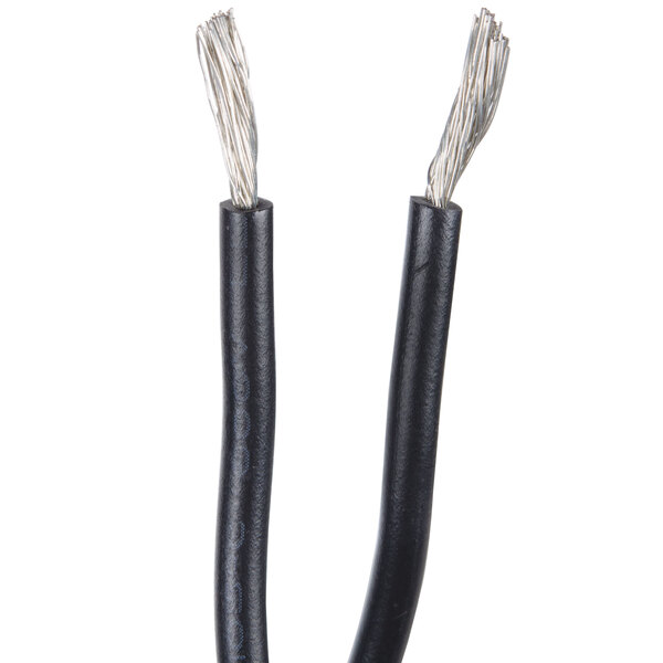 A close up of a black object with two black wires and white wires.