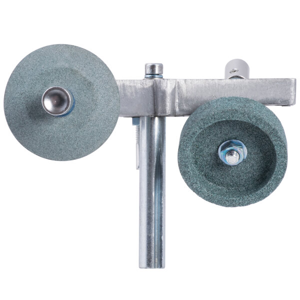 A metal pole with a pair of round stone grinding wheels on a metal stand.