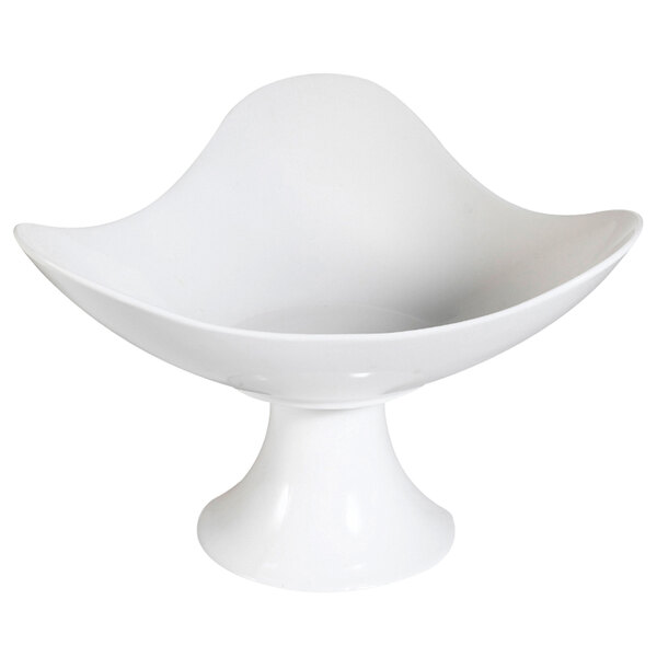 A bone white porcelain footed bowl with a curved edge and base.