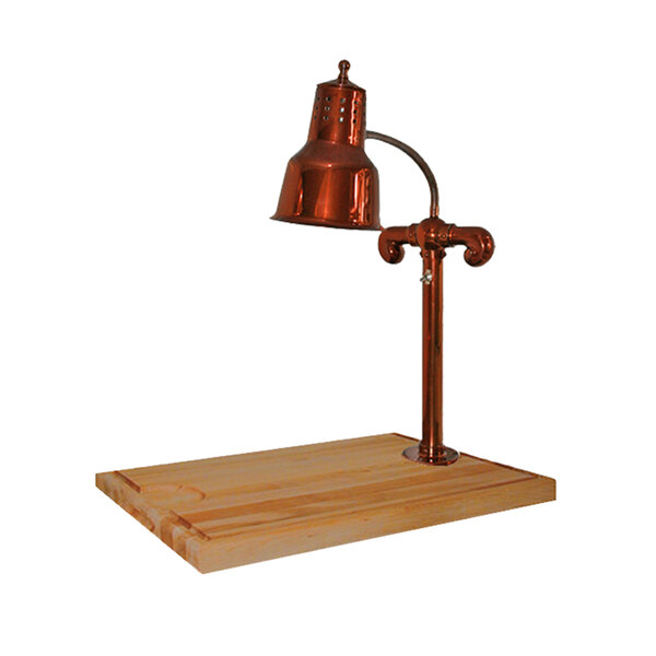 A Hanson Heat Lamps smoked copper carving station with a maple block base and gravy lane with a copper lamp on a wooden surface.