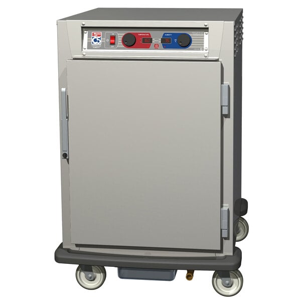 A large stainless steel Metro C5 heated holding and proofing cabinet with clear and solid doors and wheels.