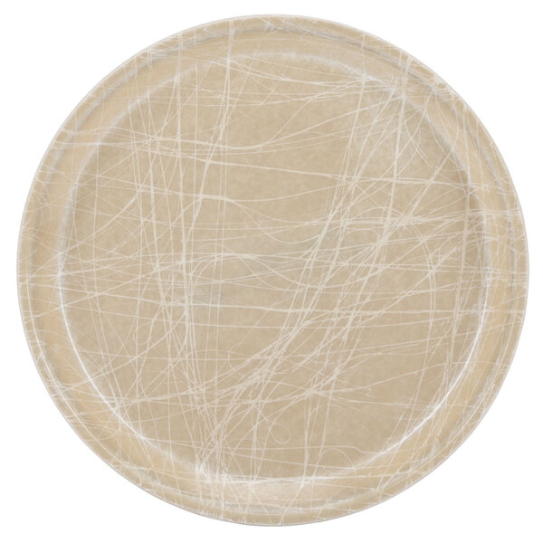 A beige Cambro round fiberglass tray with a white abstract design.