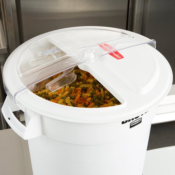 A white Rubbermaid ingredient bin with a rotating lid and a scoop inside.