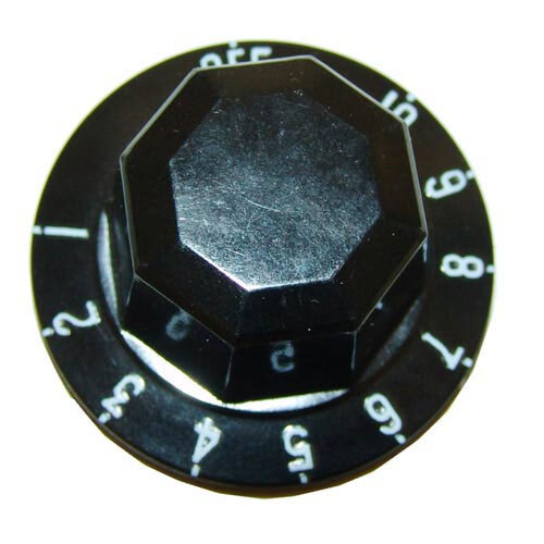 A black knob with white numbers on a metal surface.