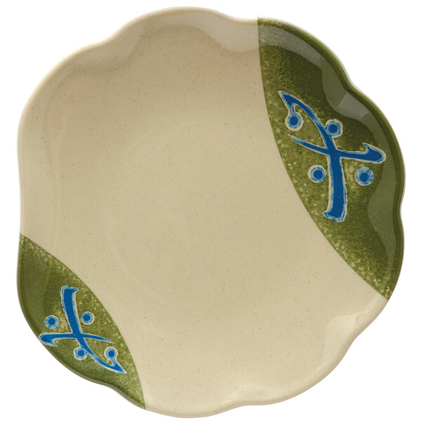 A white melamine plate with a green and blue scallop design on it.