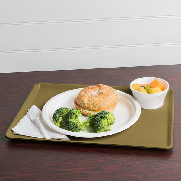A Cambro dietary tray with a plate of food including broccoli and a sandwich.