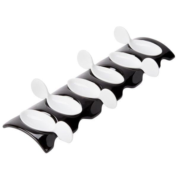 A white rectangular spoon holder with 6 CAC Bright White porcelain spoons inside.