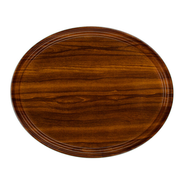 A Cambro oval wood grain fiberglass tray with round edges.