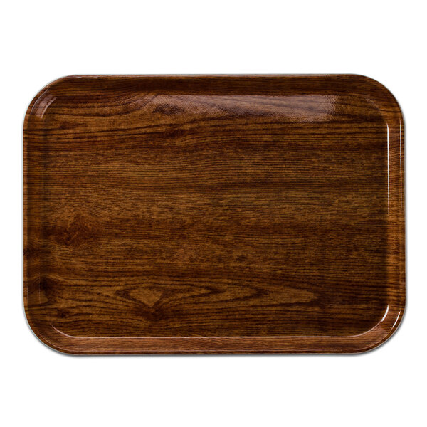 A Cambro rectangular fiberglass tray with a Country Oak finish on a table.