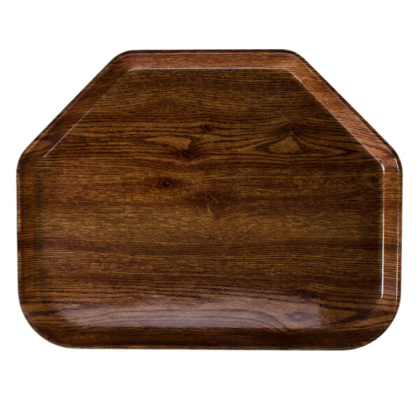 A trapezoid-shaped wooden Cambro cafeteria tray on a table.