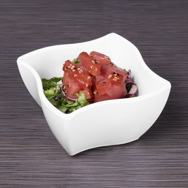 A white Elite Global Solutions square melamine bowl filled with raw tuna and salad.
