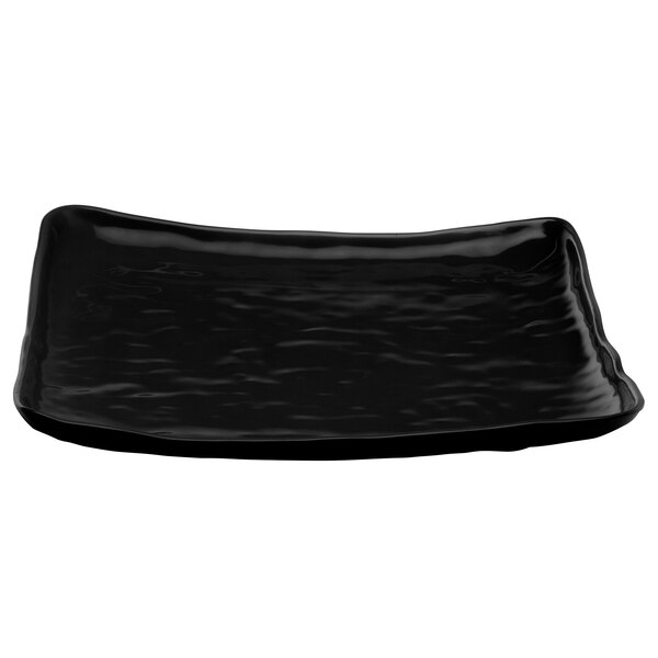 A black square melamine plate with wavy edges.