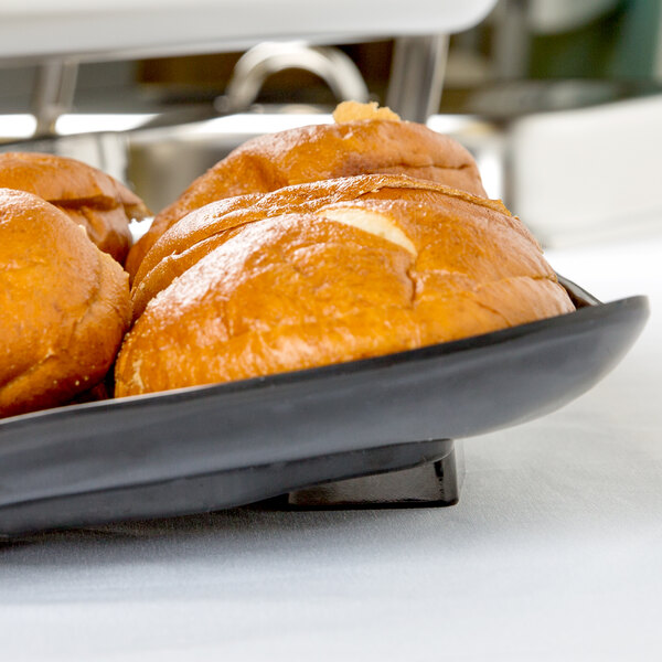 Elite Global Solutions black melamine tray with bread on it.