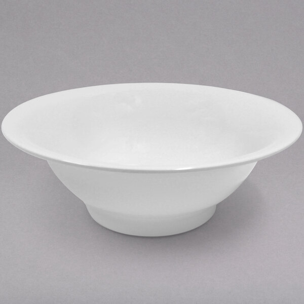 A white Elite Global Solutions flared bowl on a gray surface.