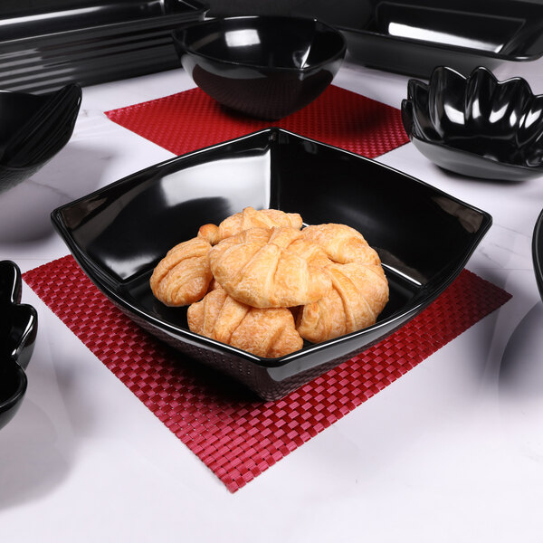 An Elite Global Solutions black melamine bowl with food in it.