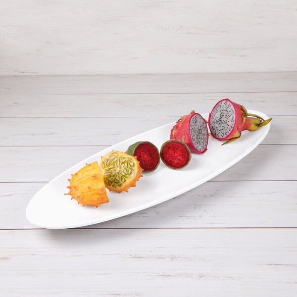 An Elite Global Solutions Moderne white melamine oblong platter with fruit on it.