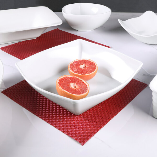 An Elite Global Solutions white melamine squarish bowl on a white surface.