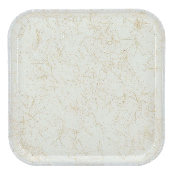 A white square tray with gold specks.