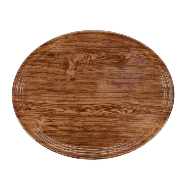 A Cambro Java Teak oval fiberglass tray with a wooden appearance.